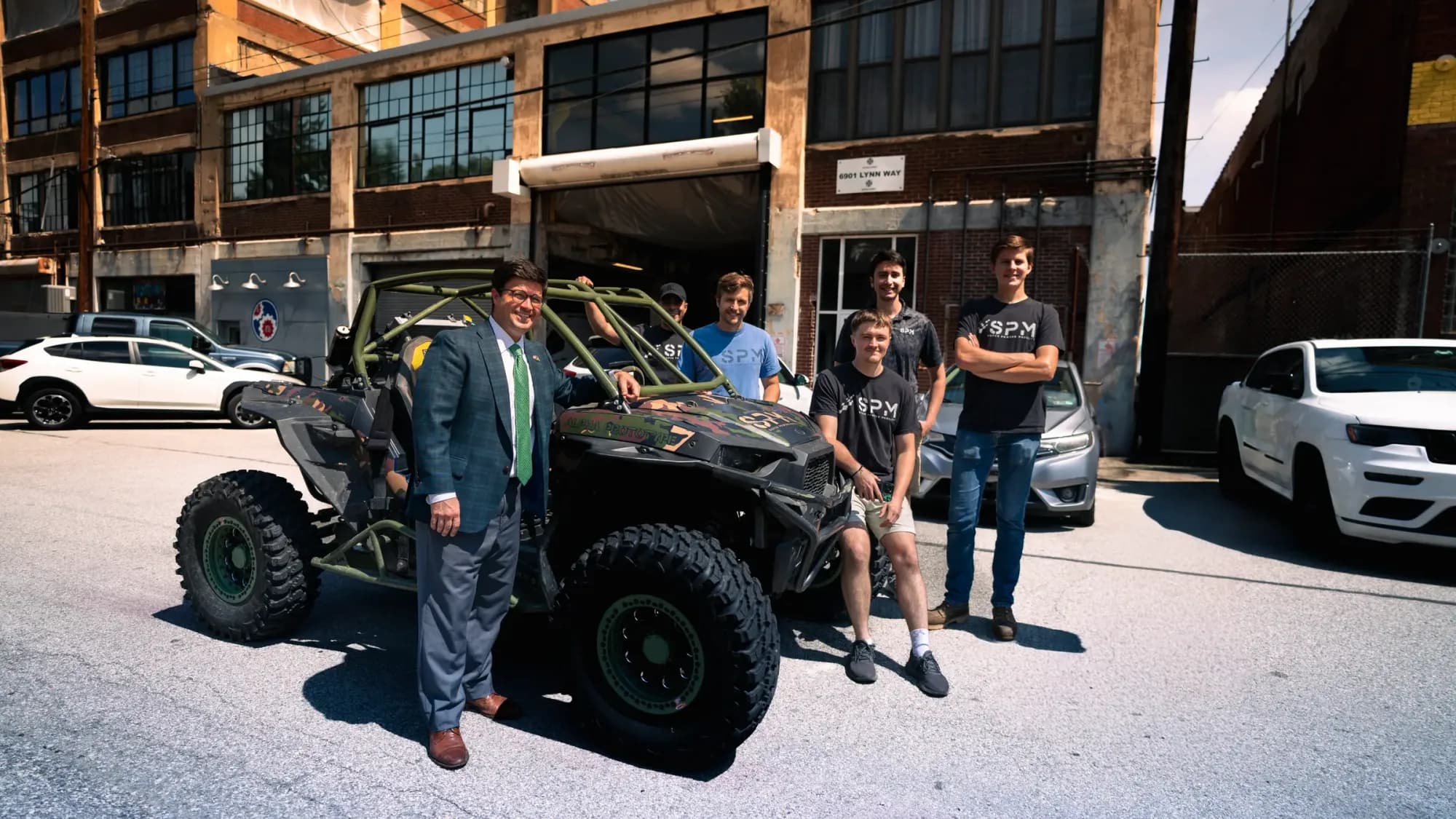 The SPM team with the Mayor of Pittsburgh and the Alpha Prototype vehicle outside the SPM facility