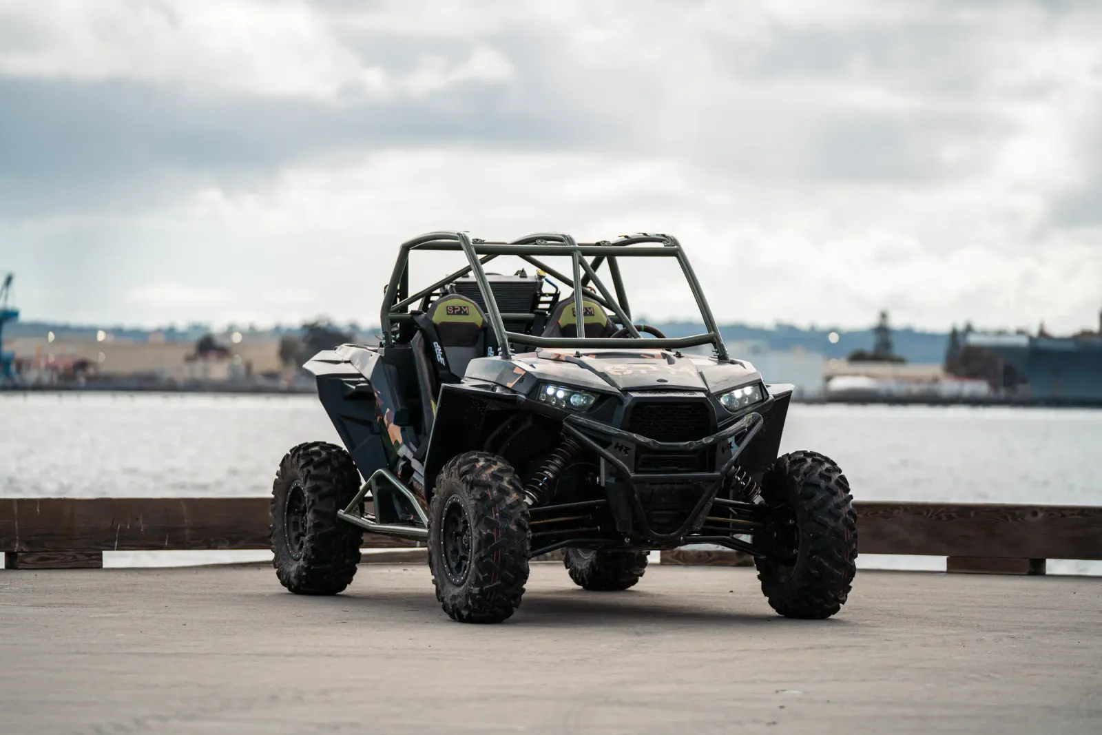 Front view of the SPM Alpha Prototype electric UTV with headlights lit